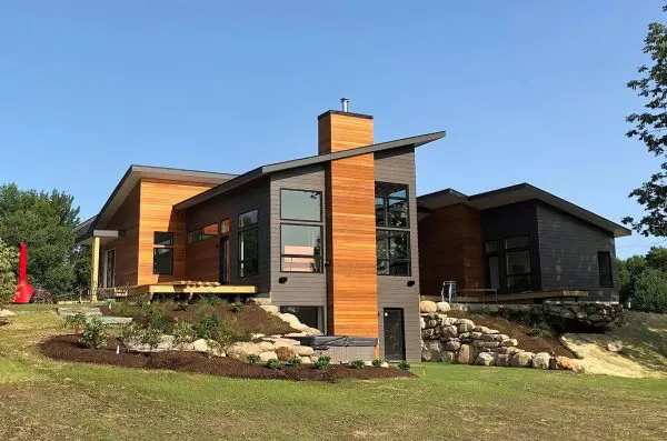 a finished black modern home with wooden accents.